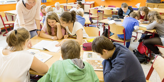 Schüler der 5. Klasse sitzen an einem Gruppentisch